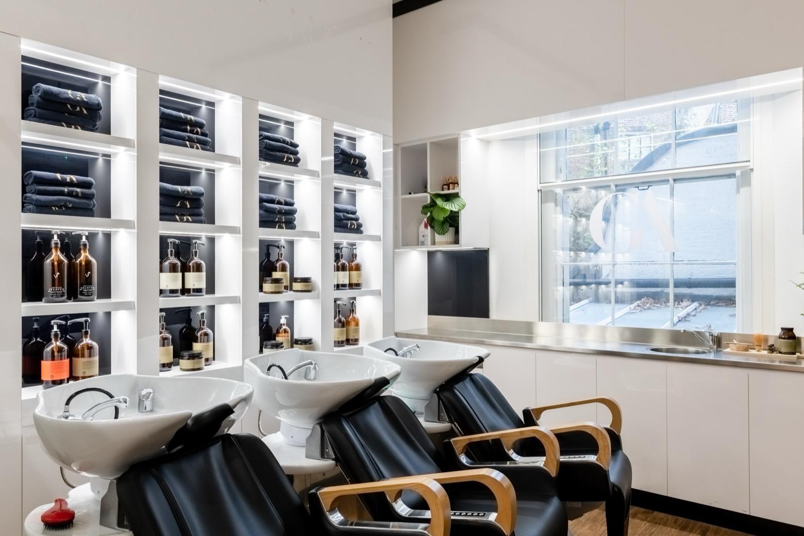 Hair washing area with black towels and haircare products